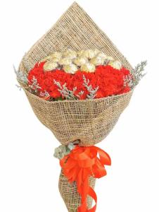 Red Carnations with 5pcs Ferrero Rocher Bouquet with red carnations, Ferrero Rocher chocolates, Misty Blue filler, Silver Dollar eucalyptus, local rosal leaves, selected wrapper, and red ribbon for delivery in Capri Quezon City